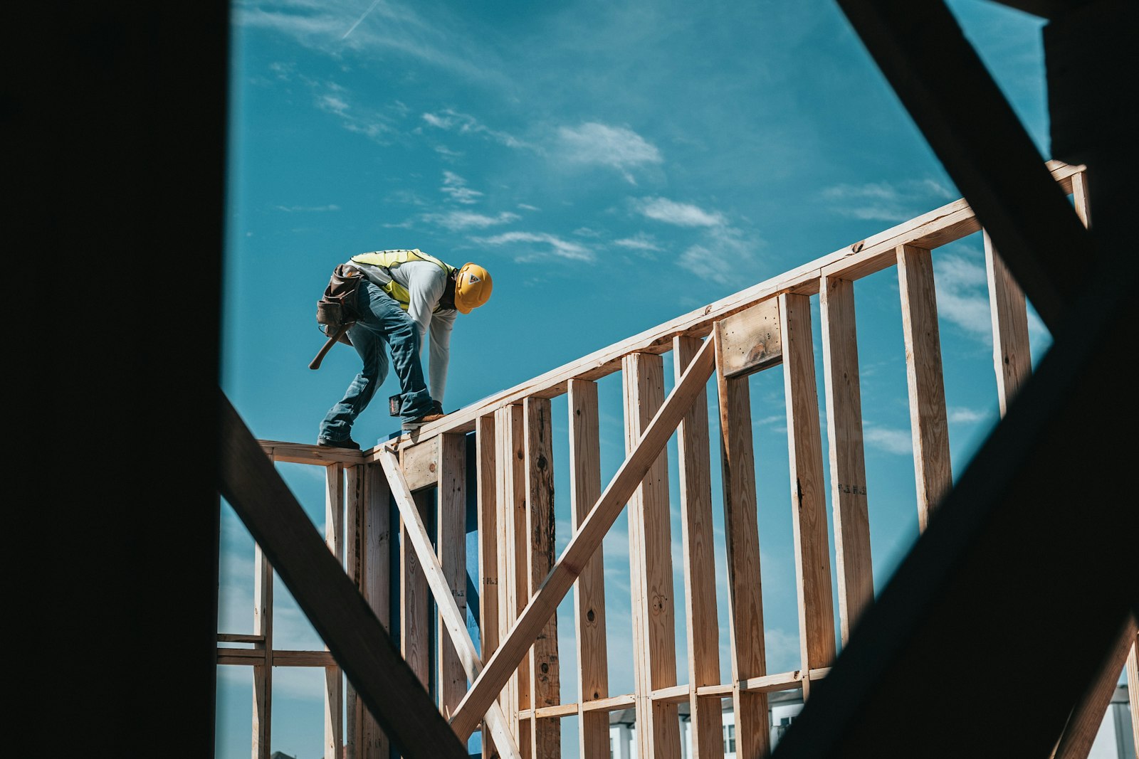 A construction worker on timber wall framing
