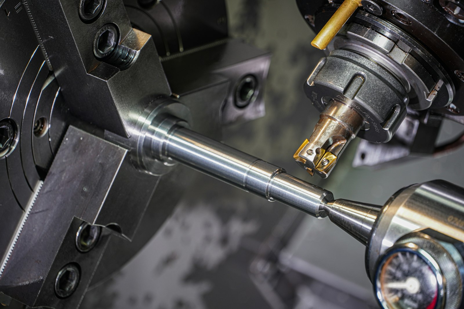 A steel rod being turned on a lathe